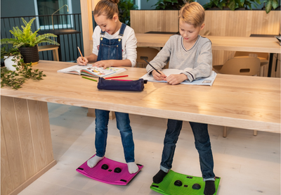 How can schools implement better ergonomics?